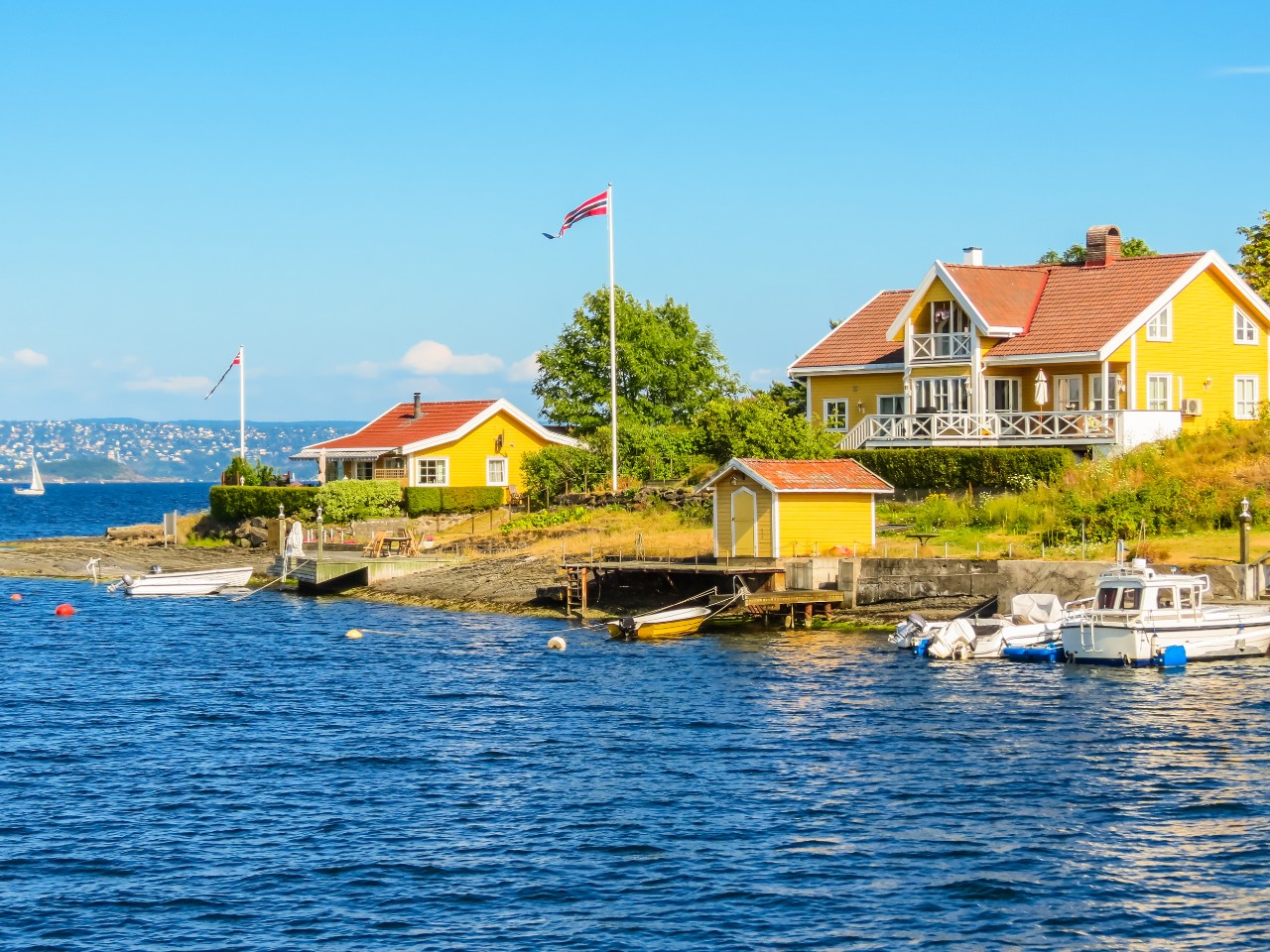Island in the Oslofjord with colorful wooden houses and barren terrain.