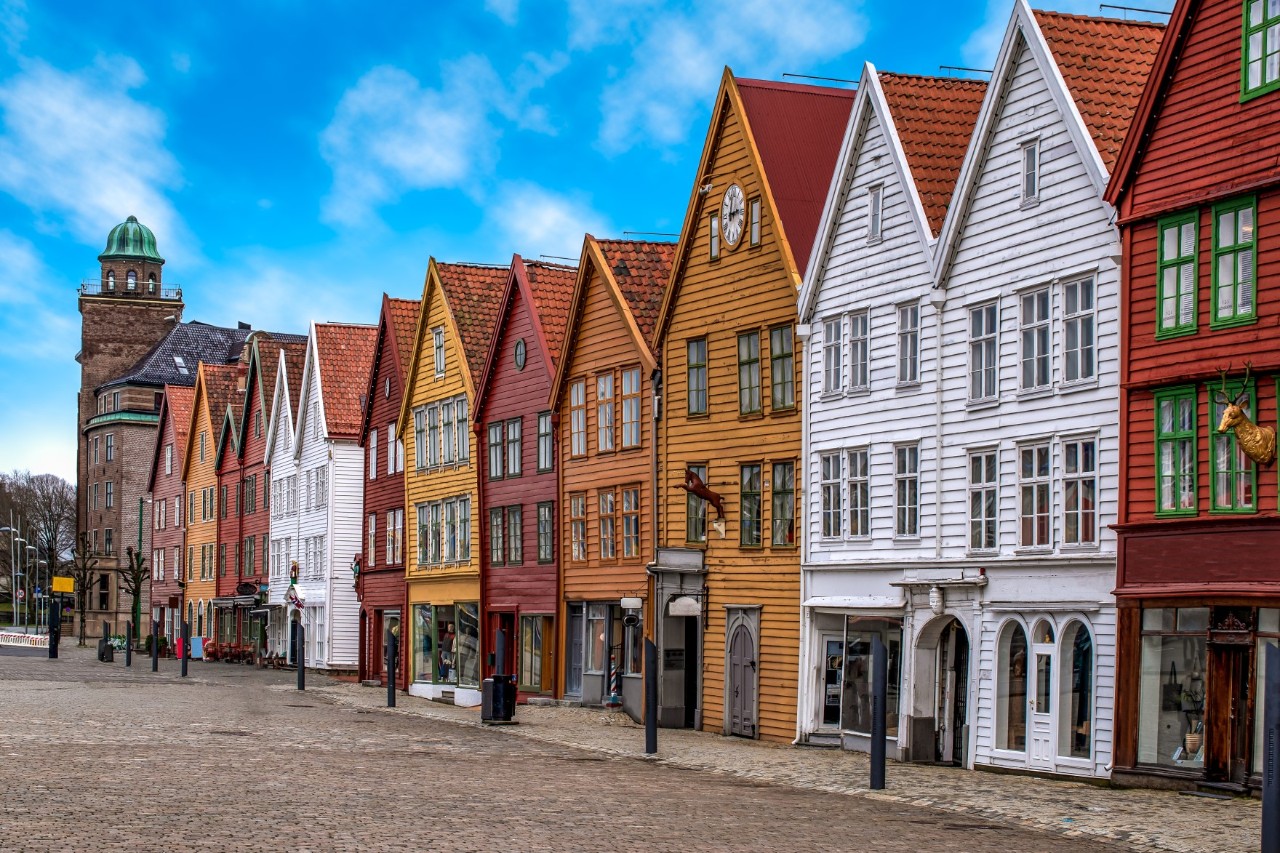 Colorful wooden Bryggen buildings in Bergen by the water in daylight.