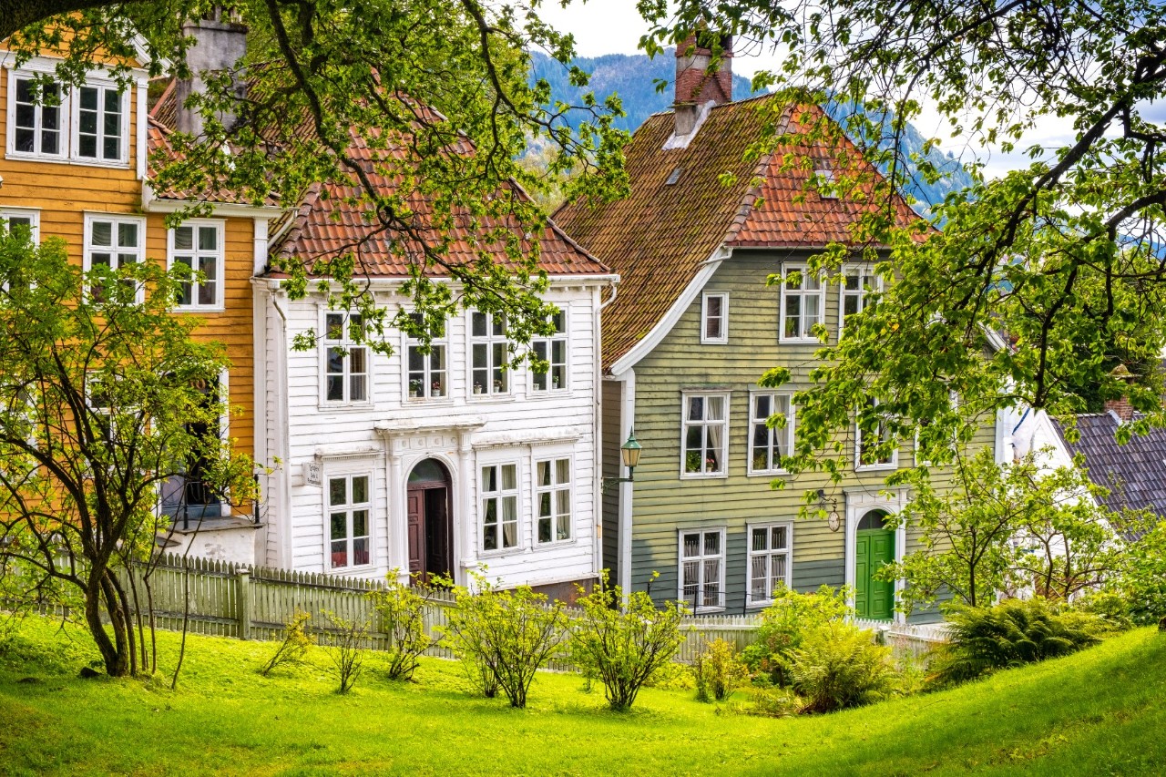 Historic wooden houses at Gamle Bergen open-air museum with garden.