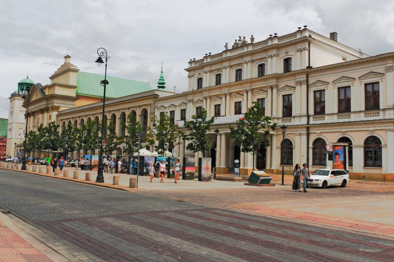 Warsaw's Royal Route with historic buildings and people strolling.
