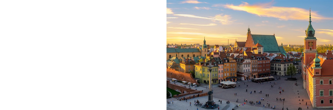 Market square in Warsaw with historic houses in warm evening light.