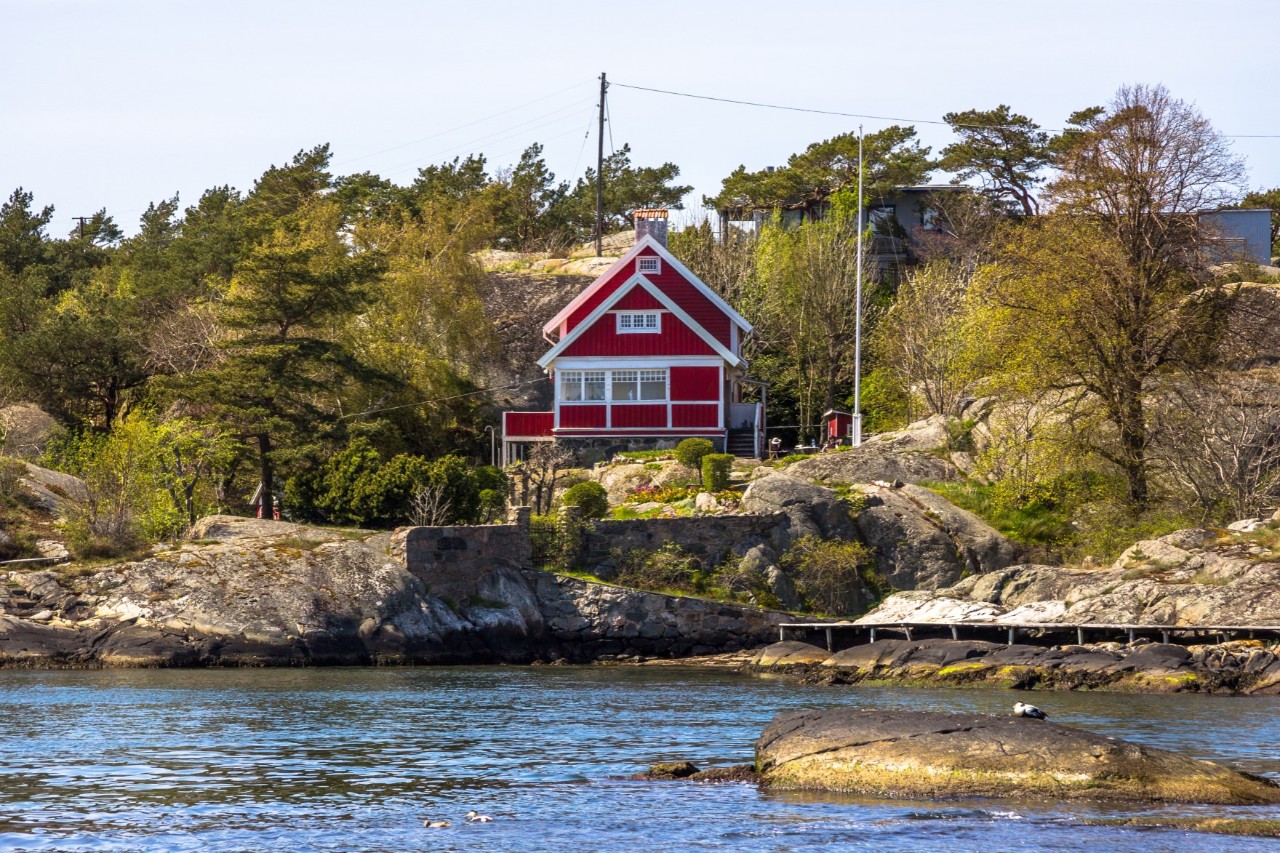 Wooden house on the Brannö Island, red house on the water © weixx/stock.adobe.com  