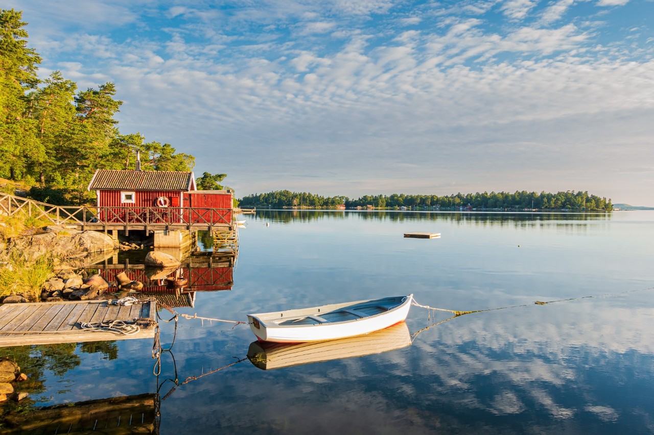 Log cabin with boat on the island of Hönö, fishing boats on the water, nature 