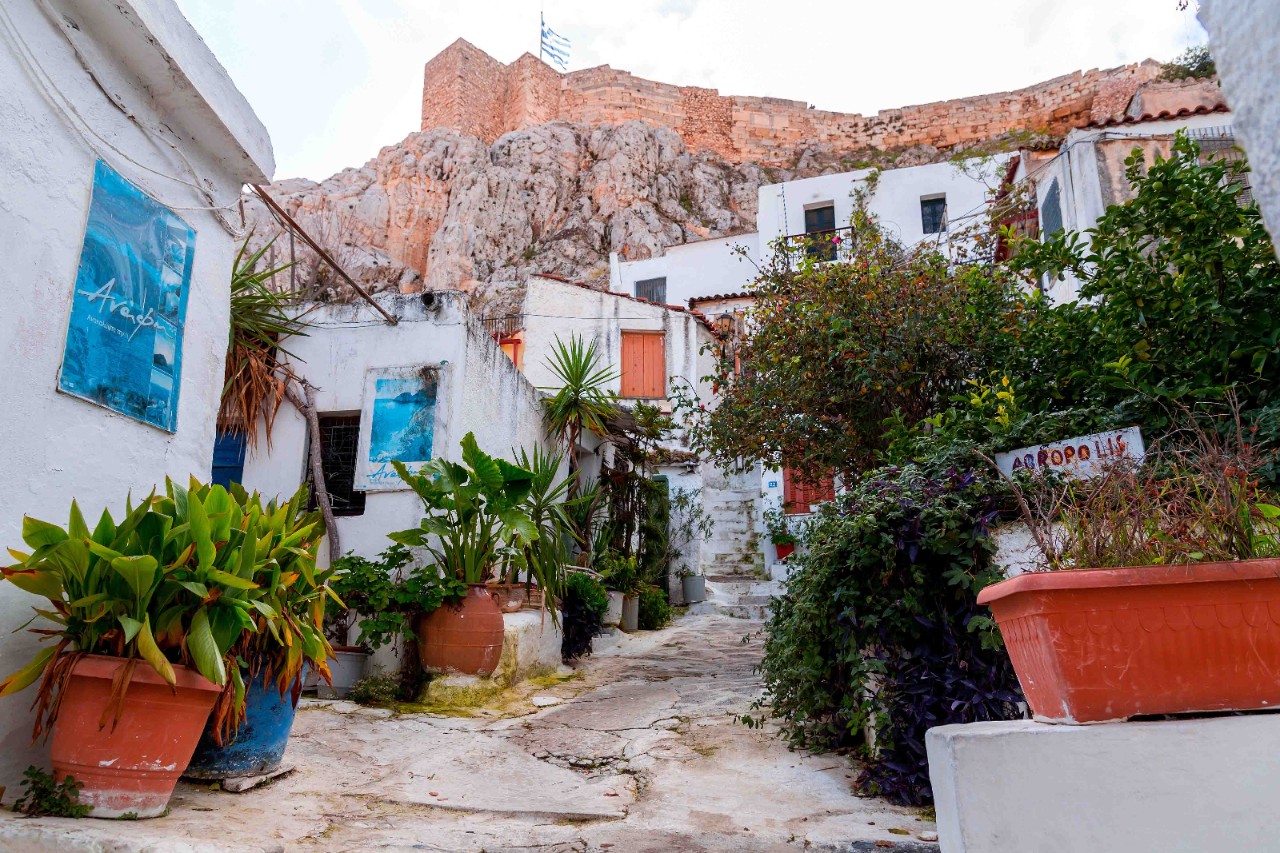 Narrow alley in the Anafiotika cliffside quarter with white houses.