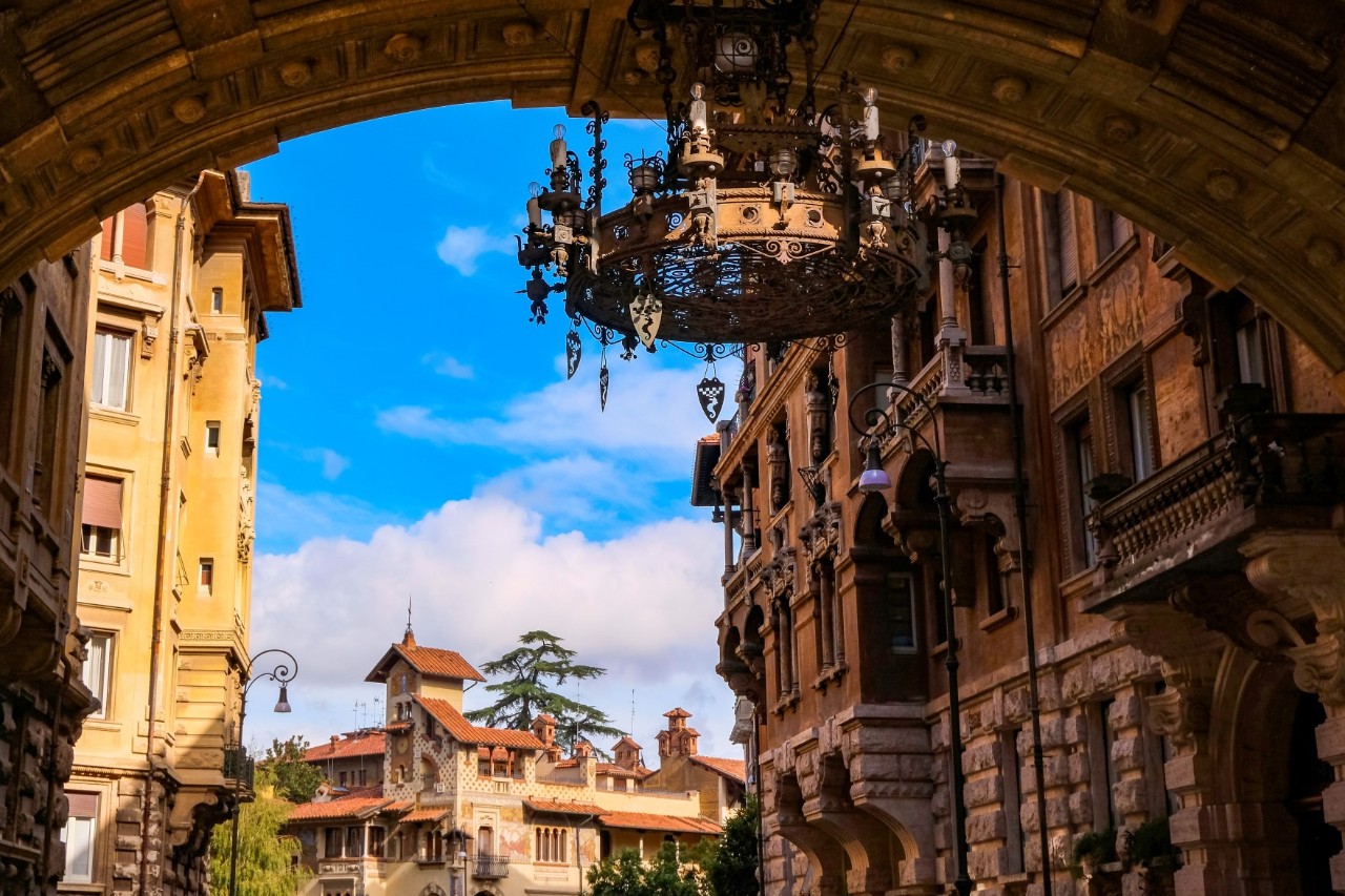 Ornate archway and buildings in Quartiere Coppedè, Rome.