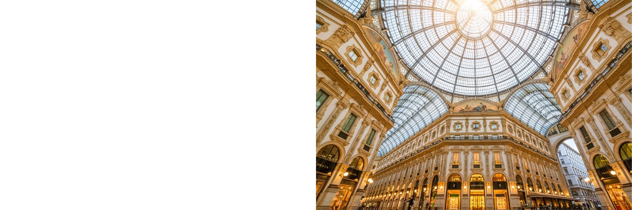Glass roof of Galleria Vittorio Emanuele II with ornate façades below.