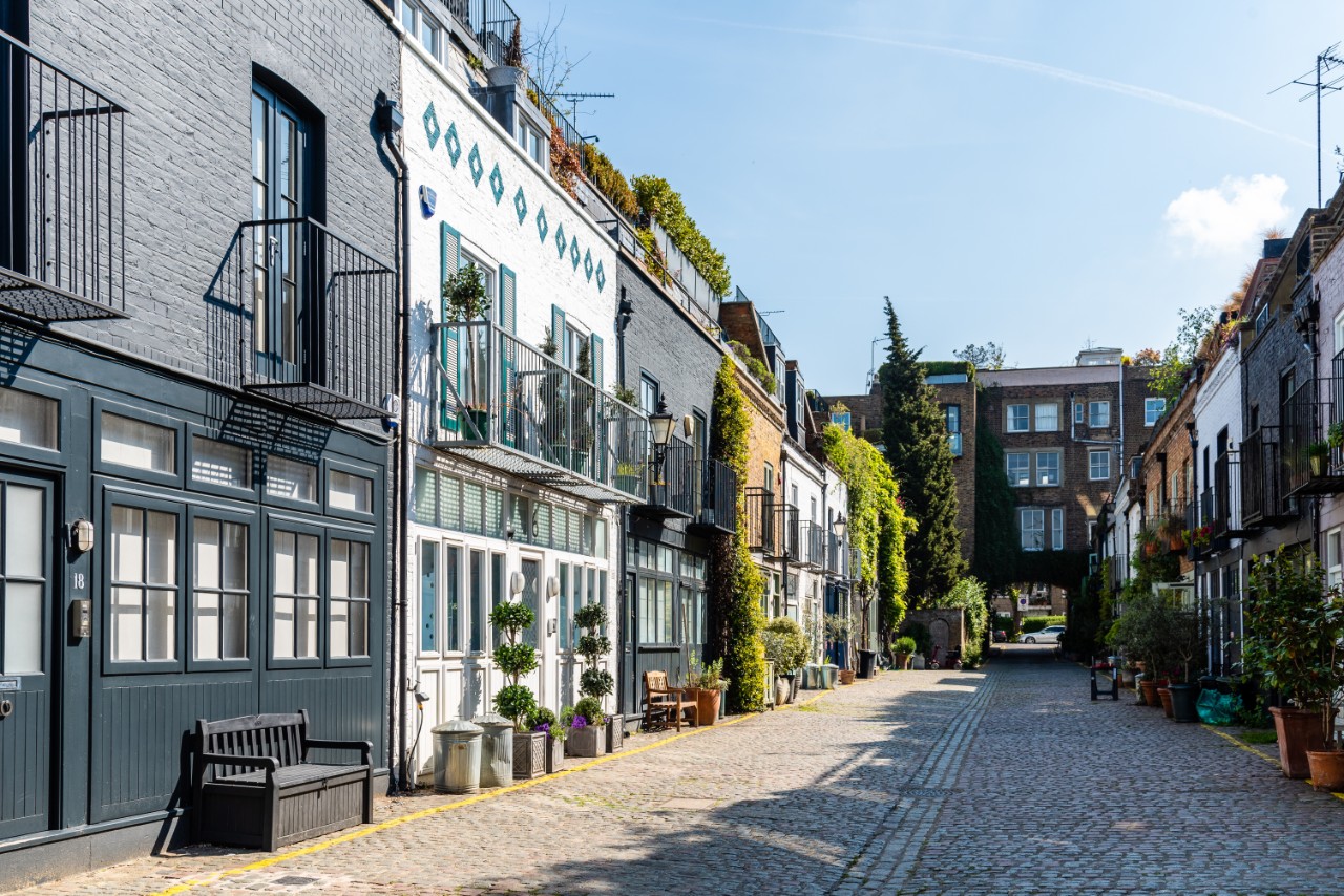 St Luke's Mews in London with colorful façades and cobblestone street.