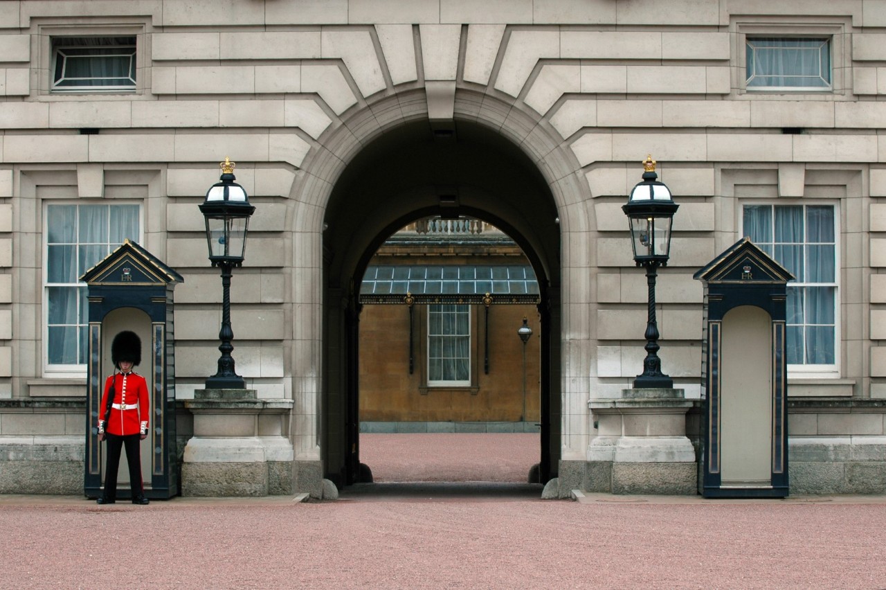 Guard in uniform in front of Buckingham Palace.