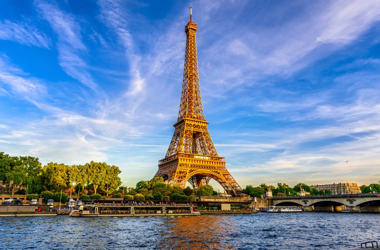 Eiffel Tower with the Seine in the foreground during daylight.