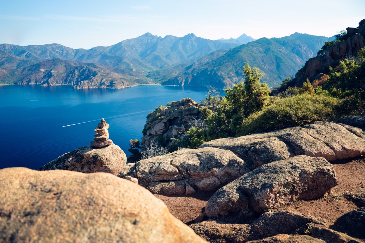 A bay surrounded by high mountains with deep blue water.
