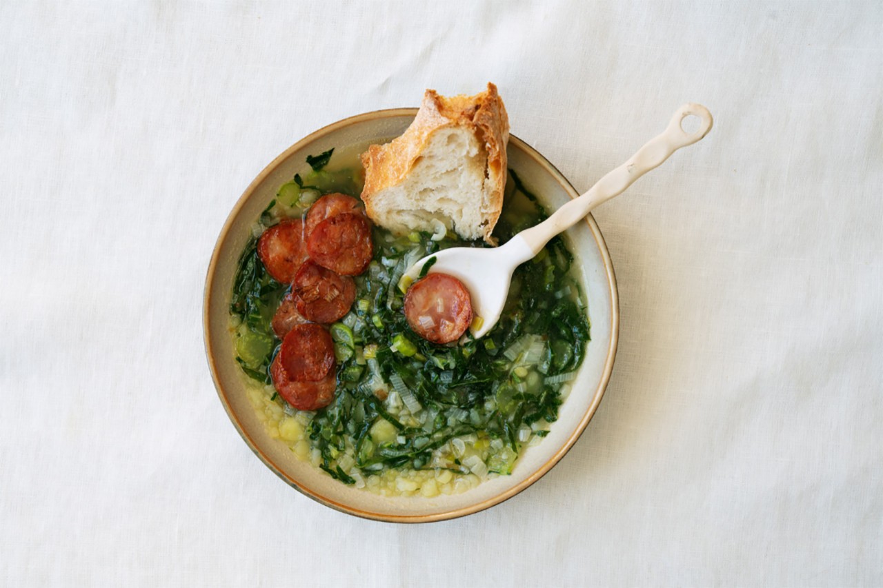 Caldo Verde stew served in a bowl with bread
