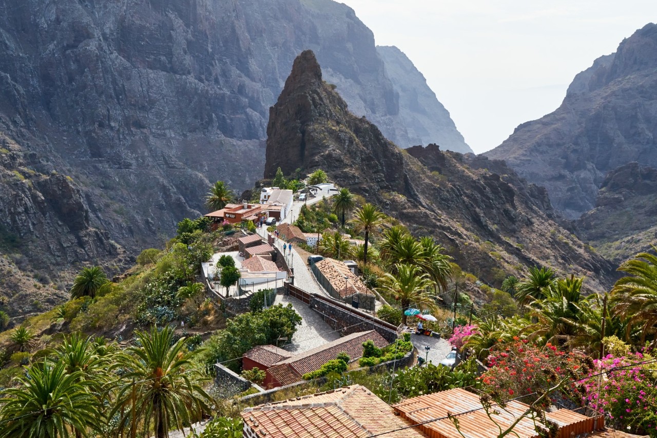 The mountain village of Masca with houses and palm trees, surrounded by mountains 