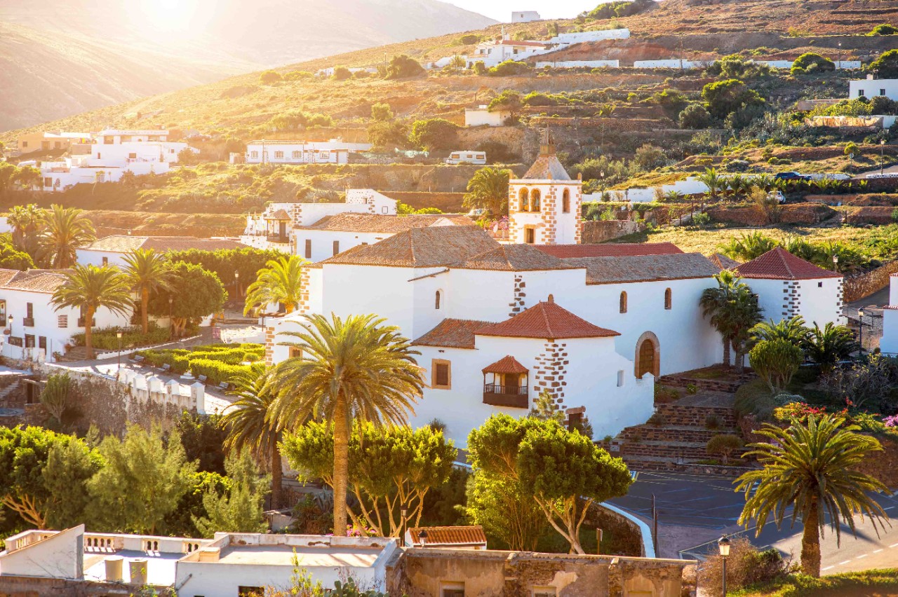 Aerial view of the church in Betancuria village with surrounding houses.