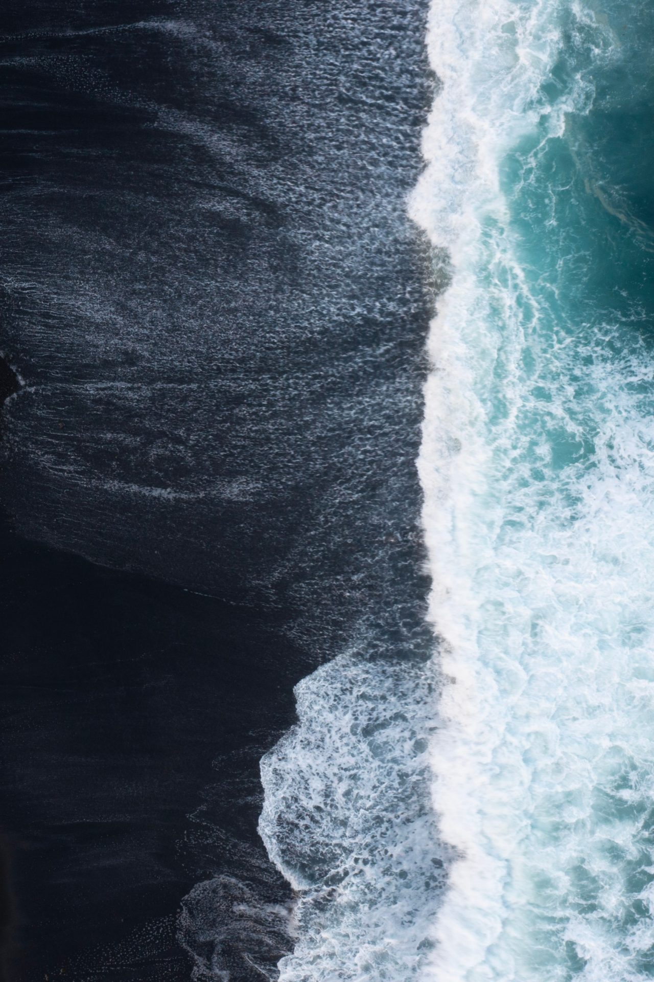 Black beach and sea