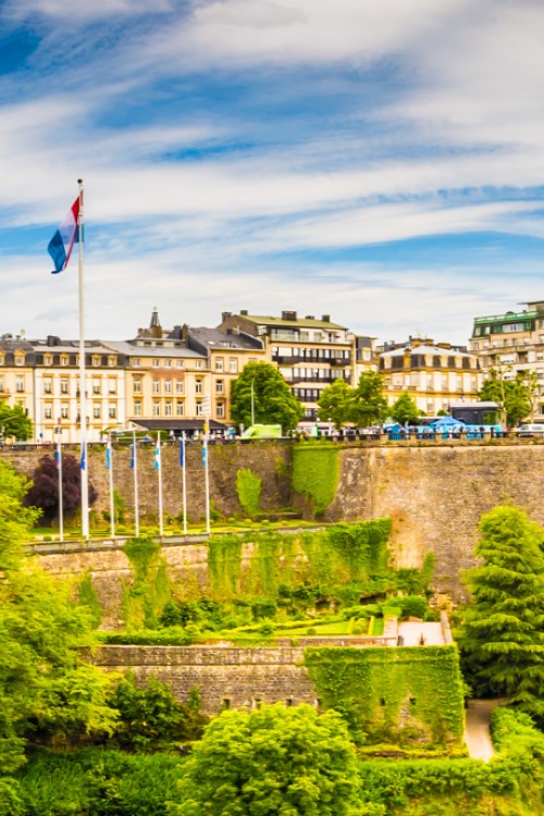 Panoramic view of Luxembourg City with fortress, buildings, church towers and lots of greenery. © powell83/stock.adobe.com