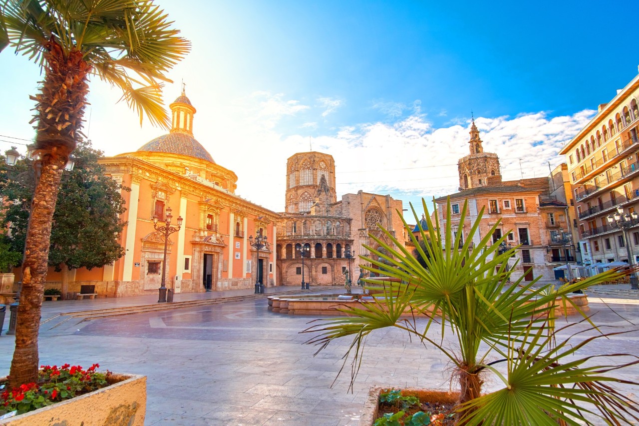 Deserted square with magnificent buildings, church towers and palm trees in the sunshine © twindesigner/stock.adobe.com 