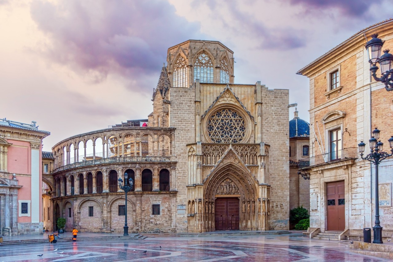 Front view of the closed cathedral in the early morning, empty square in front, purple-coloured sky 