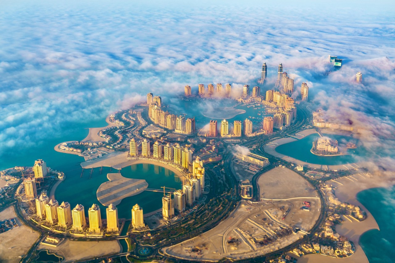 Aerial view of Qatar with skyscrapers by the sea.