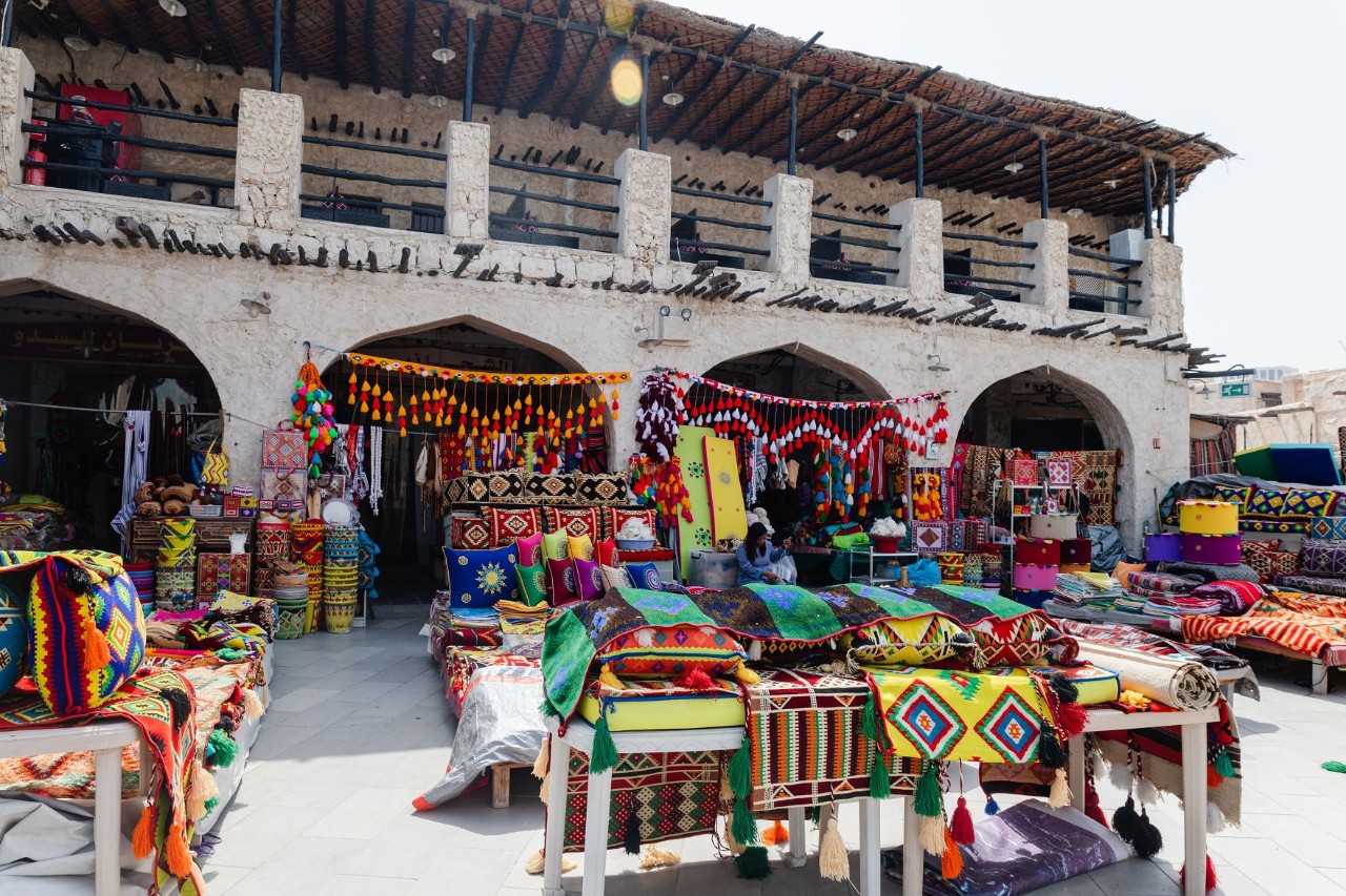 Souq Waqif with colorful shops and traditional architecture.