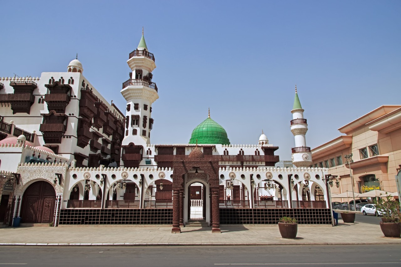 The white museum with wooden panelling and several towers. 