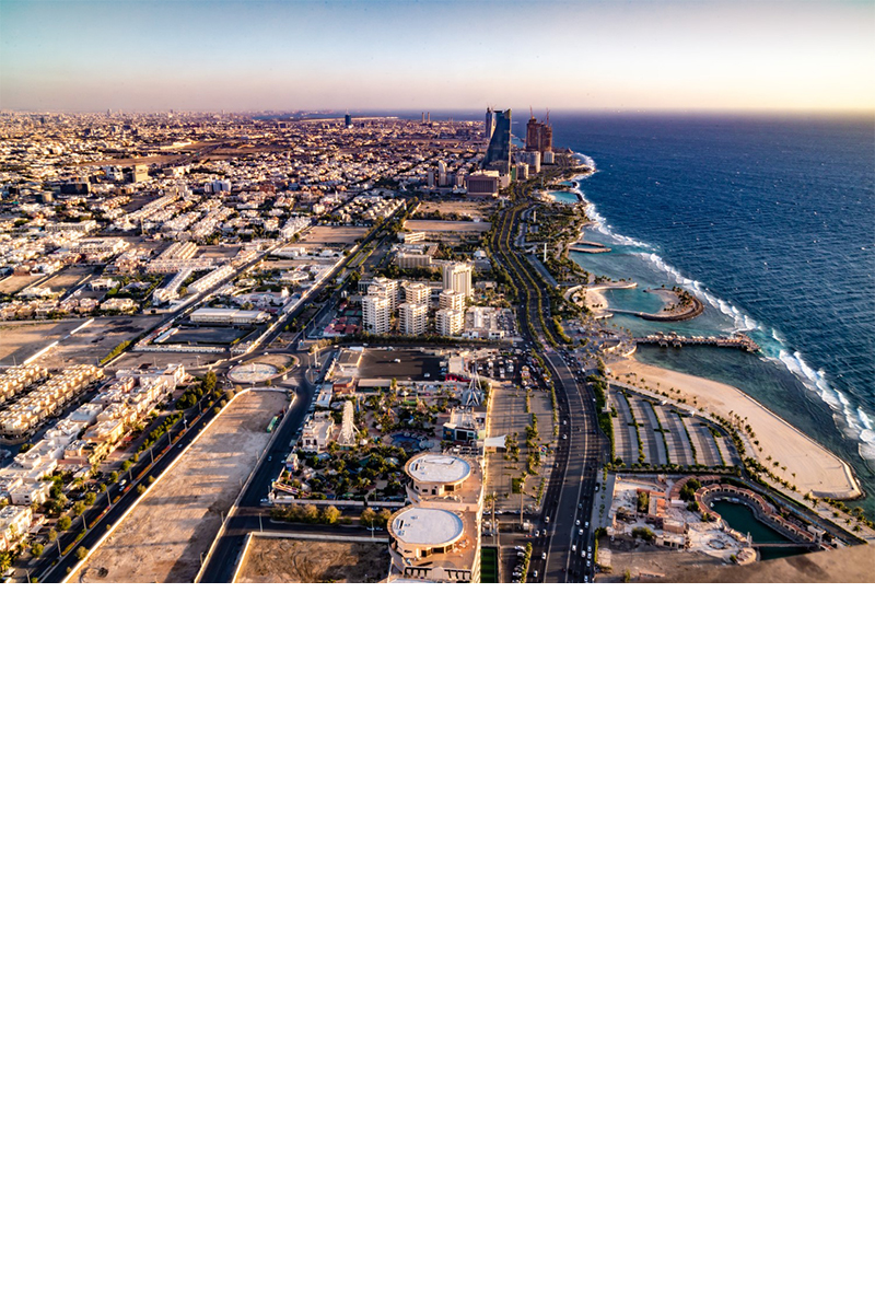 The city of Jeddah, situated on the coast, flat buildings with few structural high points near the water. 