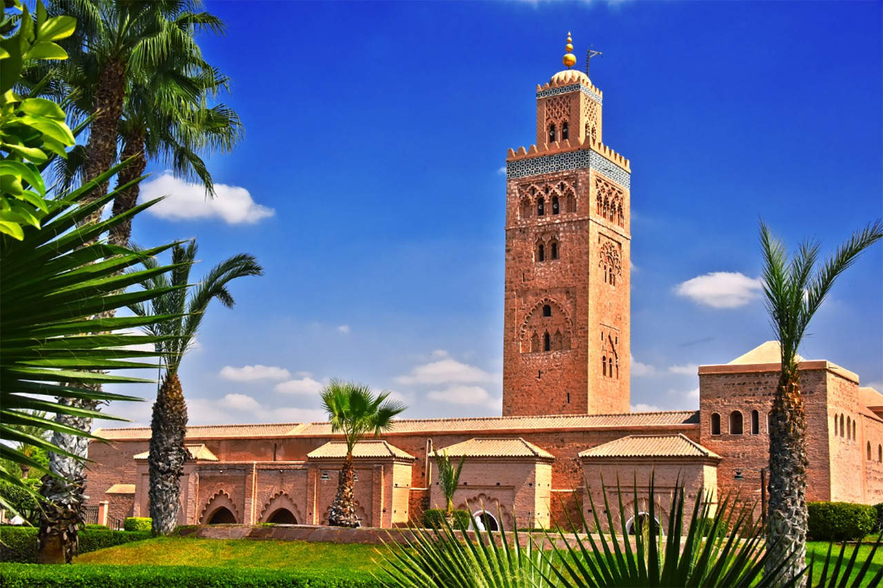 Koutoubia Mosque with minaret in Marrakesh under blue sky.