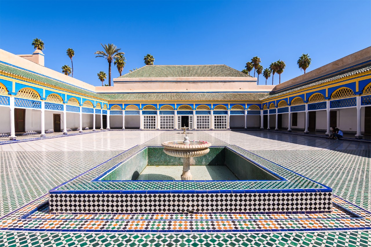 Interior of Bahia Palace in Marrakesh with ornate mosaic floor.