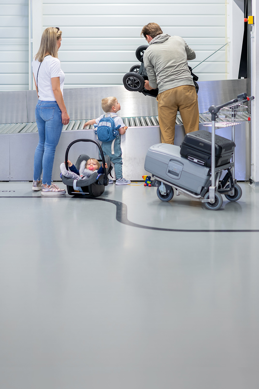 Person in front of suitcase strap with oversized baggage
