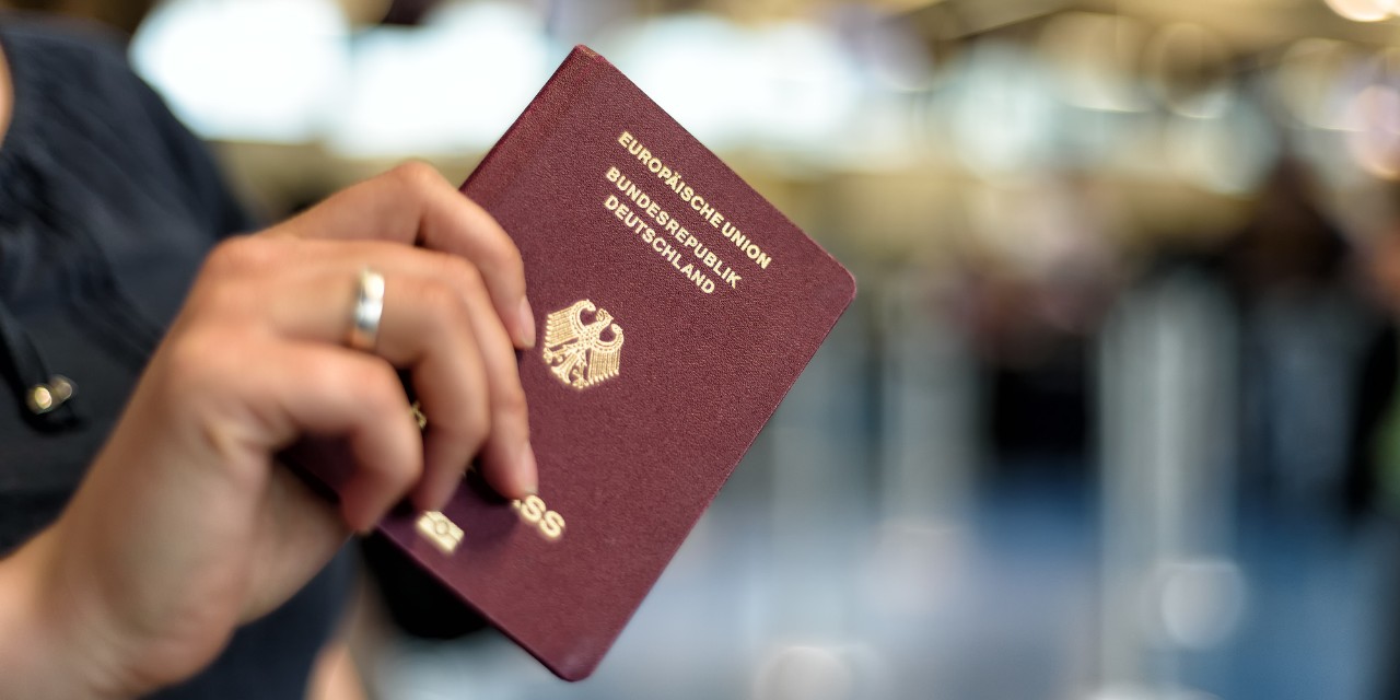 A passport in a person's hand.
