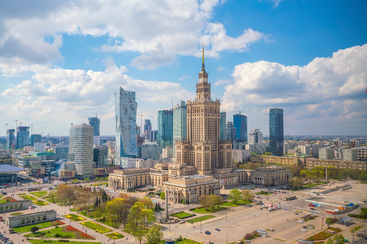 Palace of Culture in Warsaw by day with blue sky in the background.