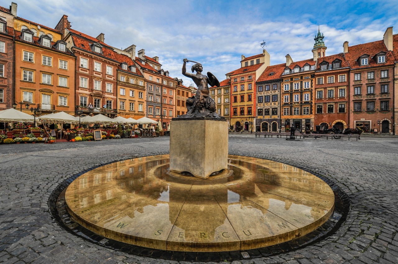 Bronze mermaid statue on Warsaw's historic Old Town Market Square.