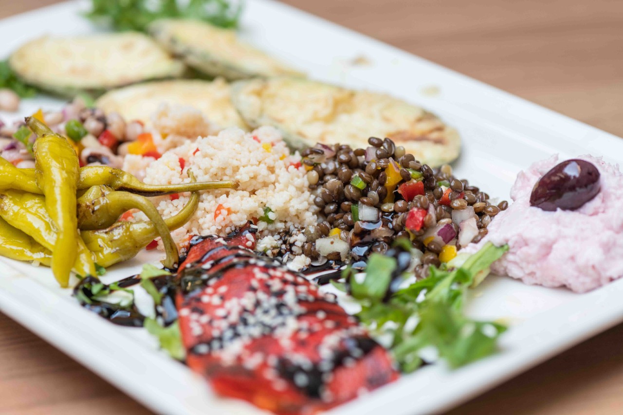 Antipasti with olives, cheese, bread, and grilled vegetables arranged.