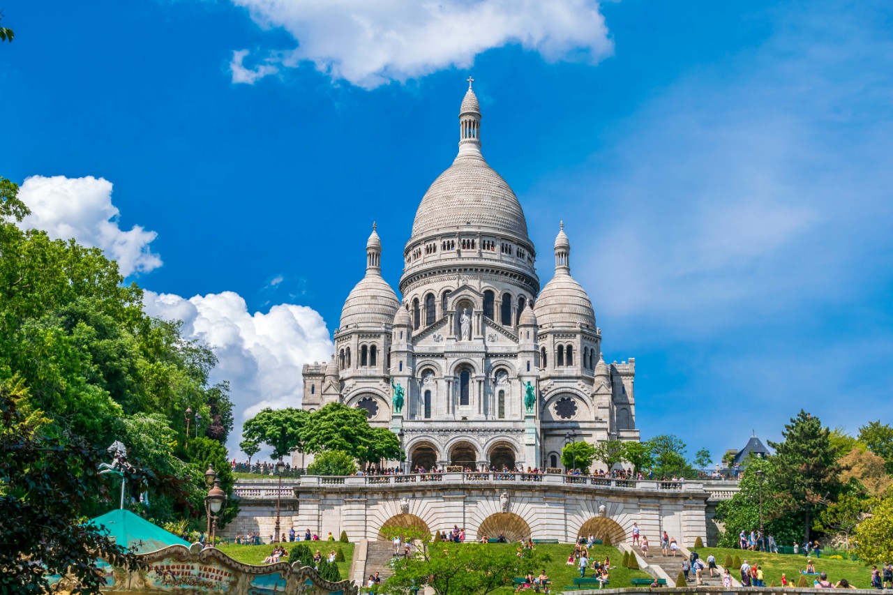 Sacré-Cœur with white dome above Paris on the hill of Montmartre.