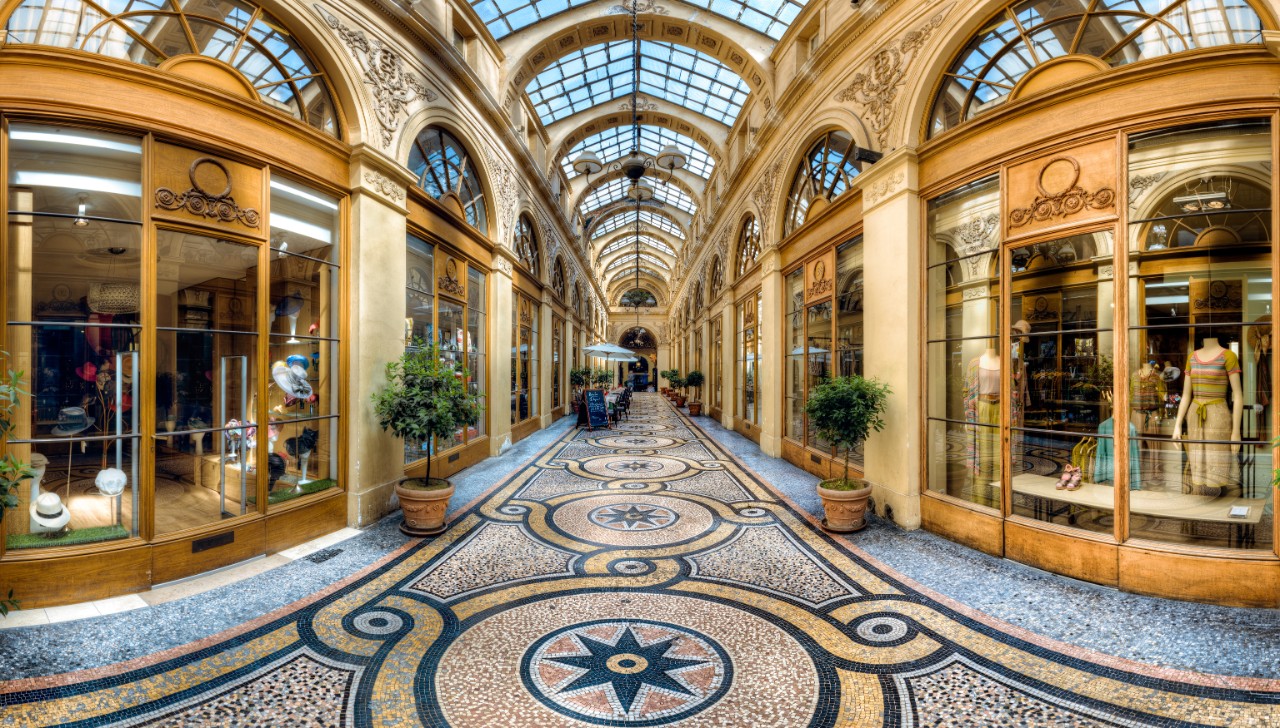 Galerie Vivienne with glass roof, mosaic floor, and elegant boutiques.