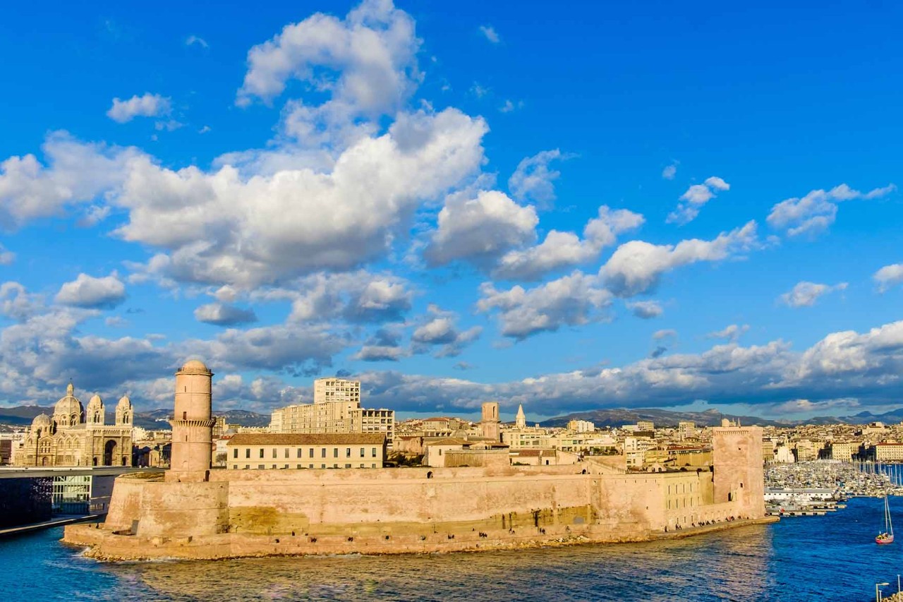 Fort Saint-Jean at Marseille's harbor entrance in sunlight.