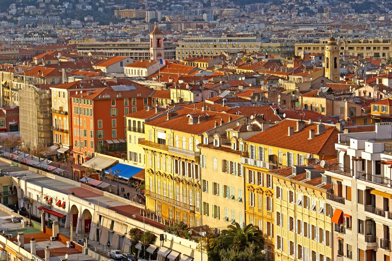 Houses of Nice’s Old Town, small shops, two church towers in the background