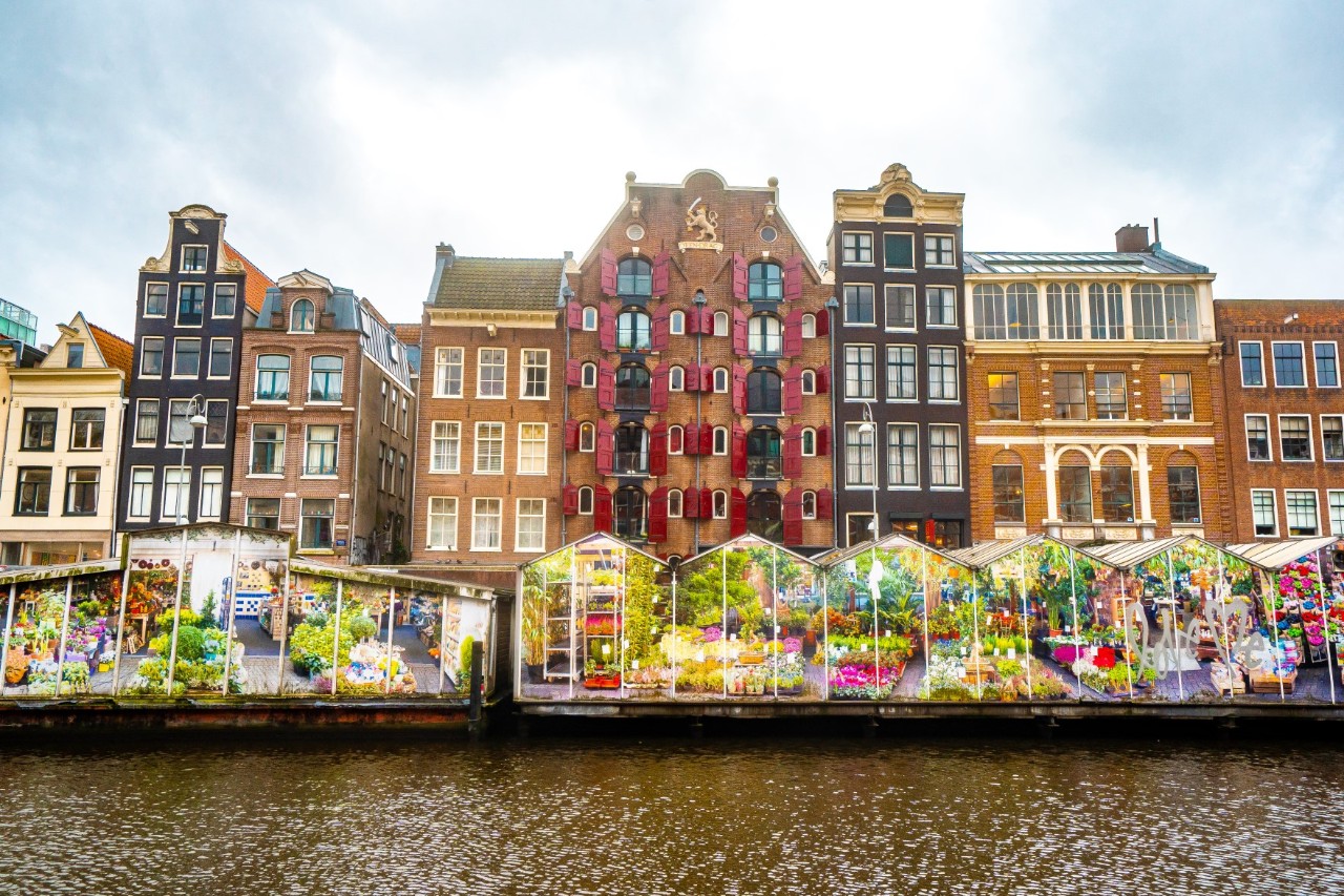 Floating flower market among colourful vendor pavilions.