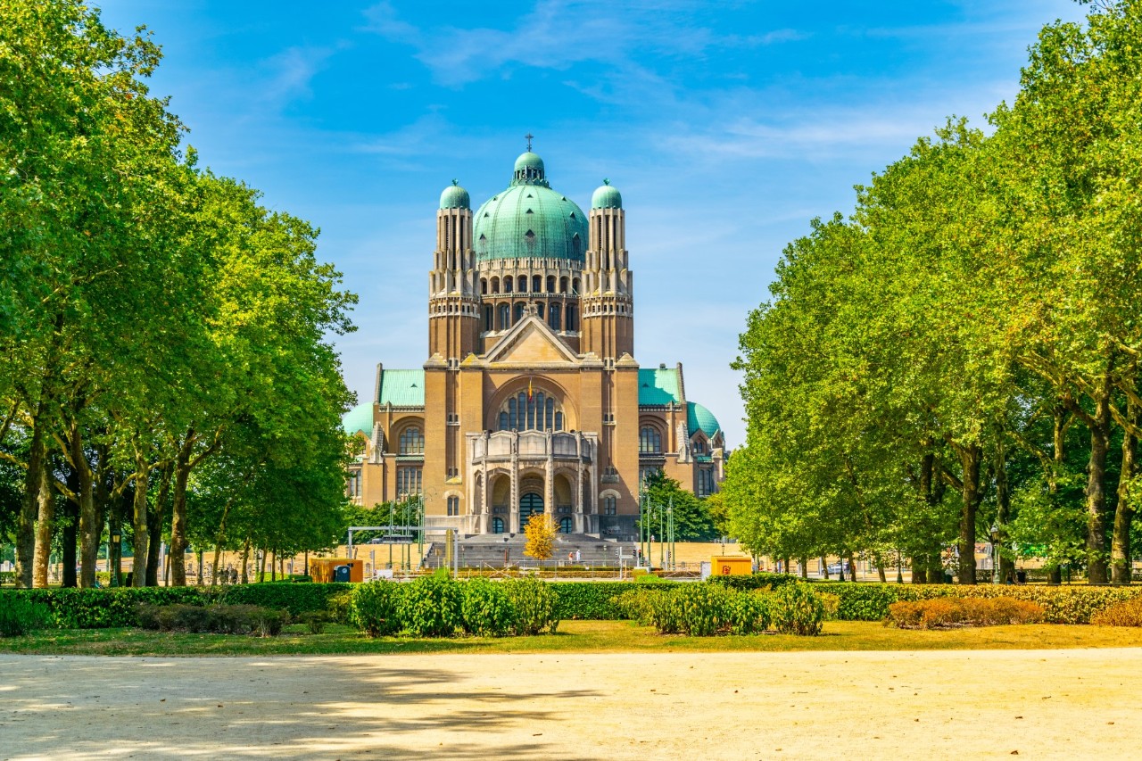 National basilica in Art Deco style, park, green trees, blue roofs, blue sky 