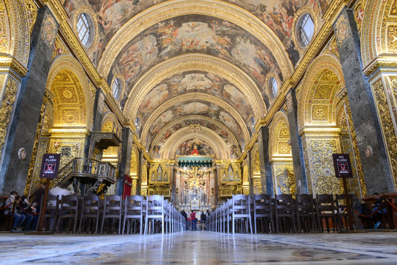 Ornate interior of St. John’s Co-Cathedral in Valletta with golden decorations.