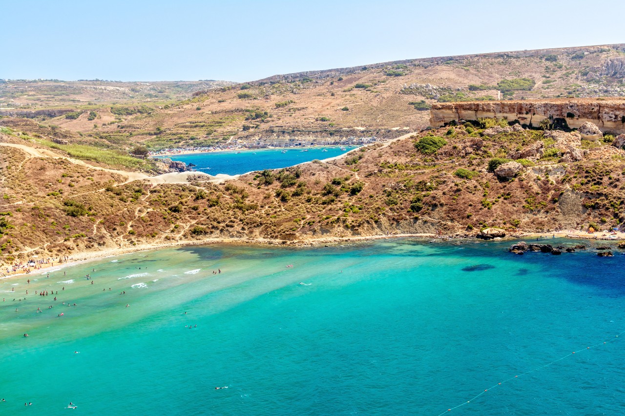 Sandy beach and clear water at Għajn Tuffieħa Bay in Malta.
