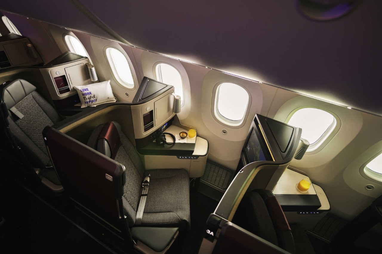 Interior of an aircraft. Seats in Business Class on Qatar Airways.