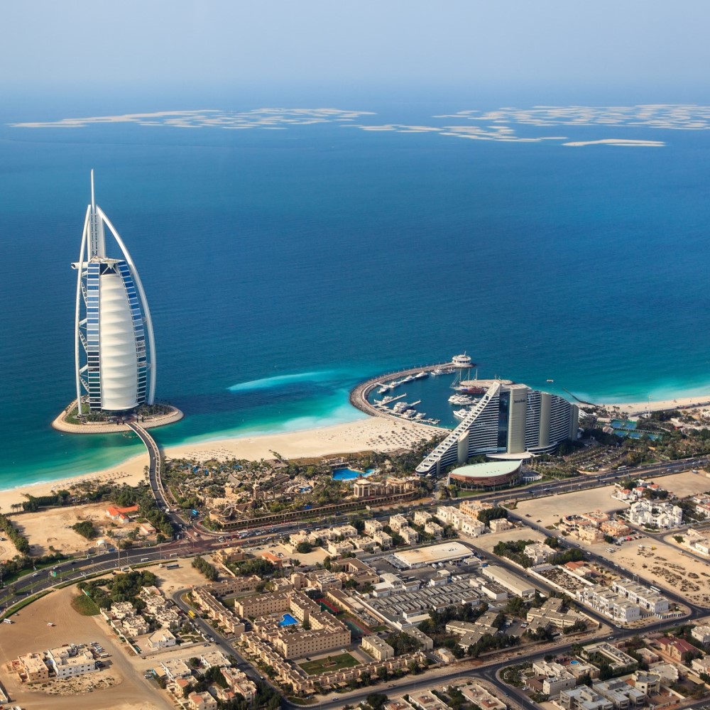 View of Dubai. A hotel in the sea. Sandy beach in front.