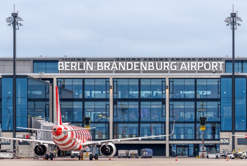 A red and white striped Condor aircraft stands on a ground handling position directly at the BER terminal.