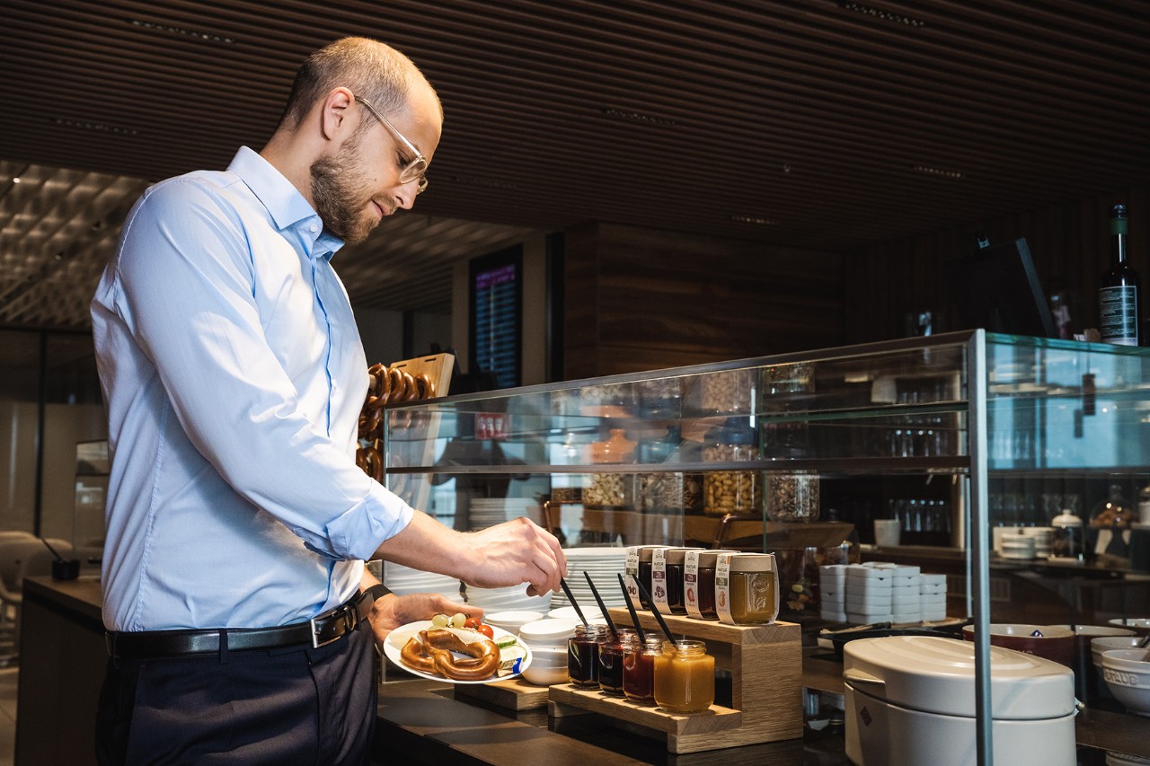 A man helps himself to a breakfast buffet.